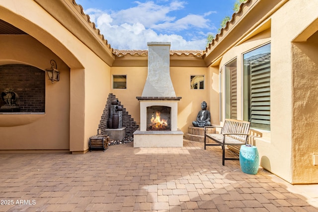 view of patio / terrace with exterior fireplace