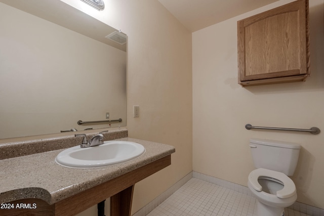 bathroom featuring toilet, tile patterned floors, and sink