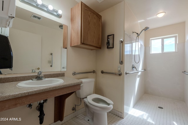 bathroom featuring tile patterned flooring, toilet, walk in shower, and sink