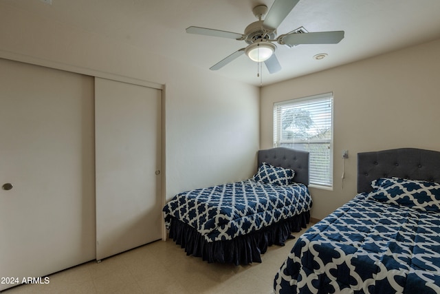 bedroom with ceiling fan and a closet