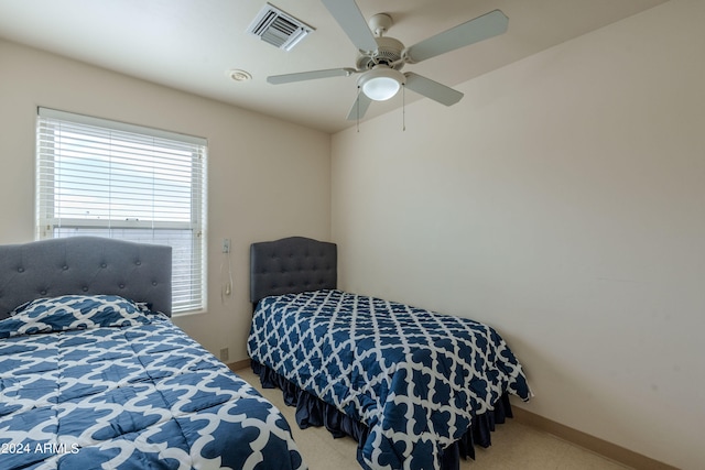 bedroom featuring light colored carpet and ceiling fan