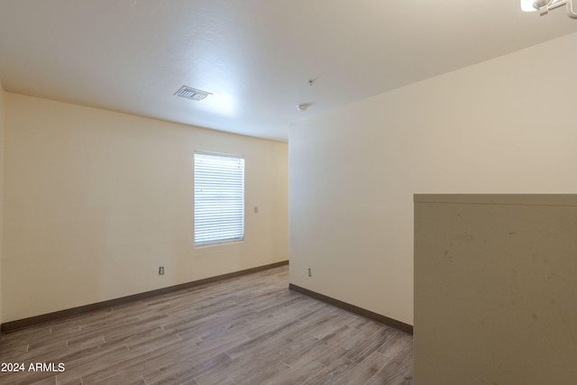 unfurnished room with light wood-type flooring