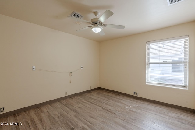 empty room with light wood-type flooring and ceiling fan