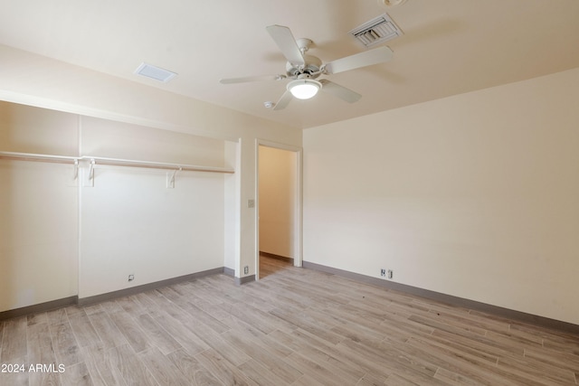 unfurnished bedroom with ceiling fan, light hardwood / wood-style floors, and a closet