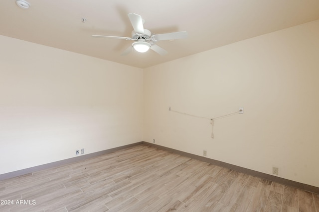 unfurnished room with light wood-type flooring and ceiling fan