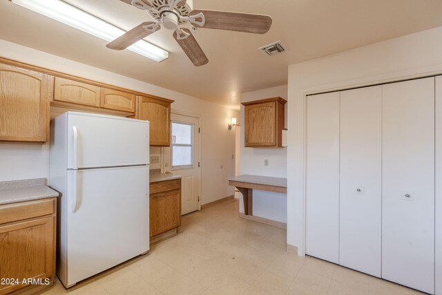 kitchen featuring ceiling fan and white refrigerator