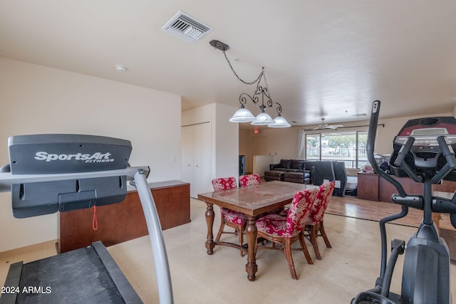 dining space with ceiling fan with notable chandelier