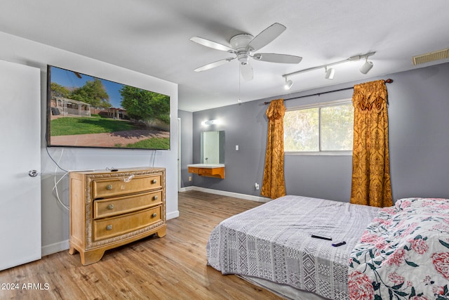 bedroom with ceiling fan and light hardwood / wood-style flooring