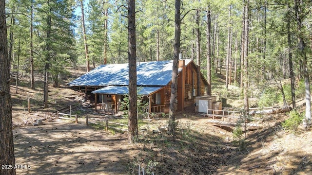197 S Hiscox Ln, Payson, AZ 85541 - view of side of property with a metal roof, a wooded view, and a porch