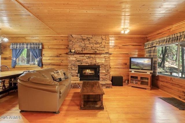 197 S Hiscox Ln, Payson, AZ 85541 - living area featuring wooden ceiling, a stone fireplace, wood finished floors, and wooden walls