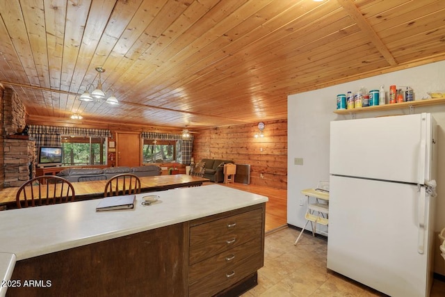 197 S Hiscox Ln, Payson, AZ 85541 - kitchen featuring freestanding refrigerator, wooden ceiling, open floor plan, wood walls, and light countertops
