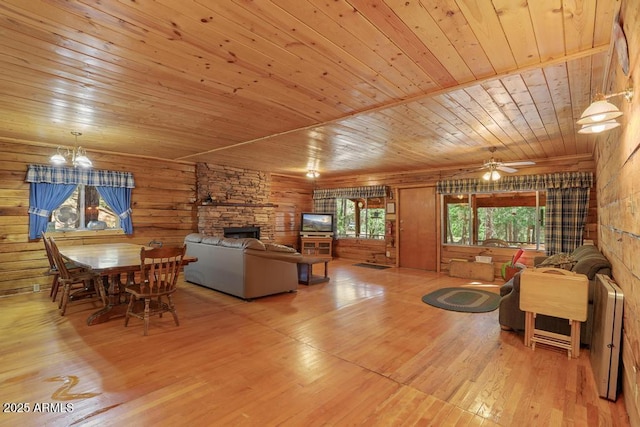 197 S Hiscox Ln, Payson, AZ 85541 - living area with wood ceiling, a stone fireplace, wood-type flooring, a chandelier, and a ceiling fan