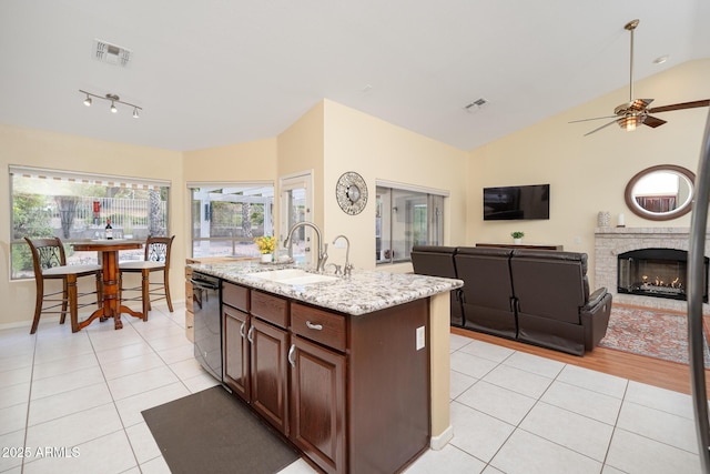 835 W Beechnut Dr, Chandler, AZ 85248 - kitchen with lofted ceiling, light tile patterned flooring, black dishwasher, ceiling fan, and an island with sink