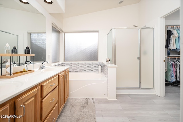 835 W Beechnut Dr, Chandler, AZ 85248 - full bathroom featuring a shower stall, a bath, double vanity, a spacious closet, and wood finished floors
