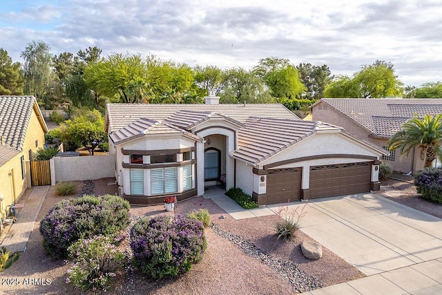 835 W Beechnut Dr, Chandler, AZ 85248 - view of front facade featuring a garage, a gate, stucco siding, and driveway