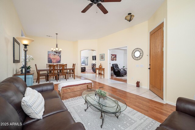 835 W Beechnut Dr, Chandler, AZ 85248 - living area with a ceiling fan, arched walkways, light wood-style floors, and a chandelier