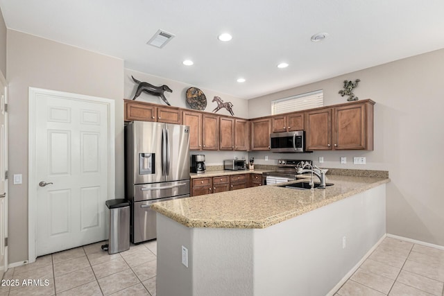 kitchen featuring stainless steel appliances, kitchen peninsula, light stone countertops, and light tile patterned floors