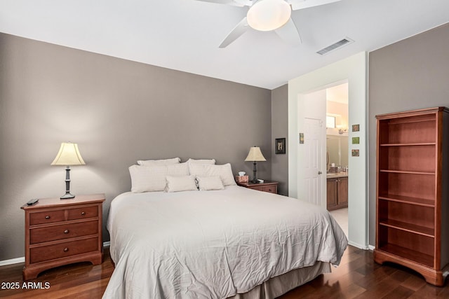 bedroom with ceiling fan, dark hardwood / wood-style flooring, and ensuite bath