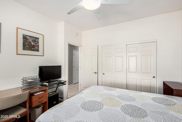 bedroom featuring ceiling fan, tile patterned flooring, and a closet