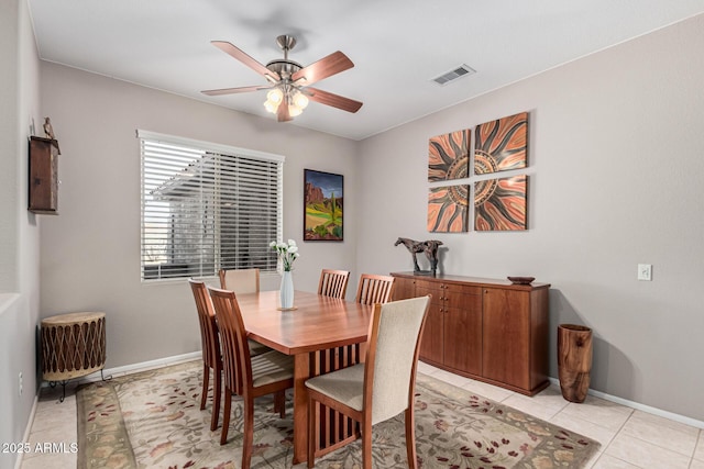 tiled dining room with ceiling fan