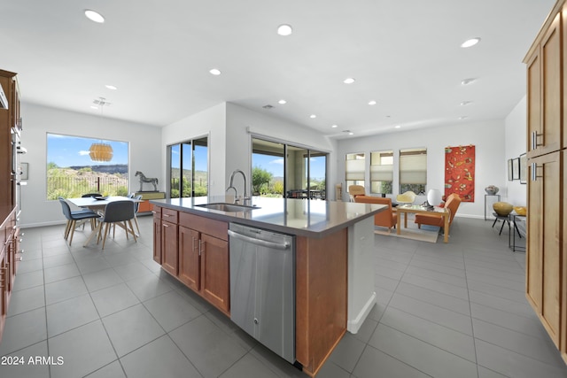 kitchen featuring an inviting chandelier, sink, hanging light fixtures, a kitchen island with sink, and stainless steel dishwasher