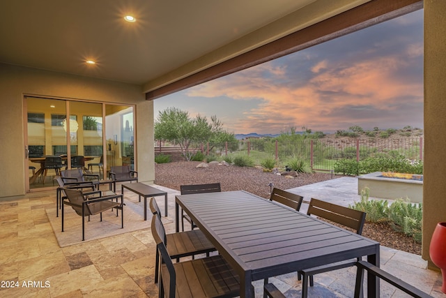 view of patio terrace at dusk