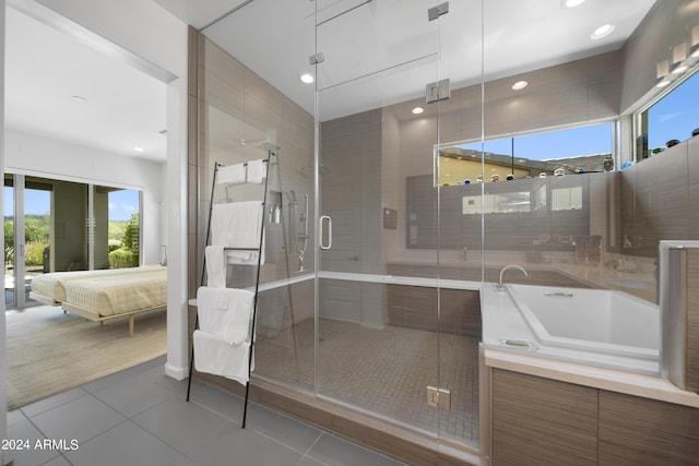 bathroom featuring tile patterned flooring, a wealth of natural light, and shower with separate bathtub