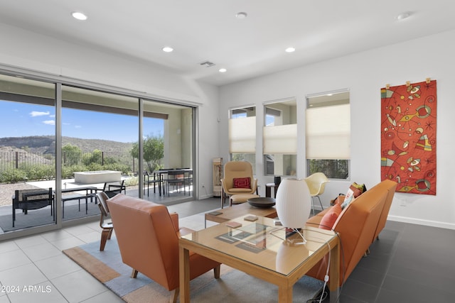 tiled living room featuring a mountain view and plenty of natural light