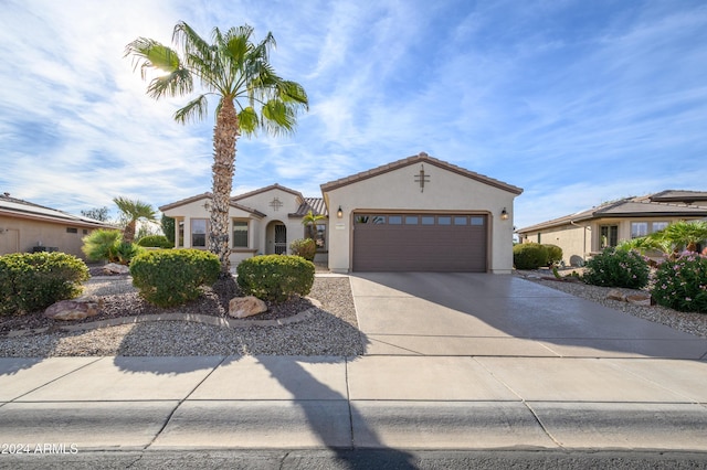 16933 W Oasis Springs Way, Surprise, AZ 85387 - mediterranean / spanish home with driveway, stucco siding, a garage, and a tiled roof