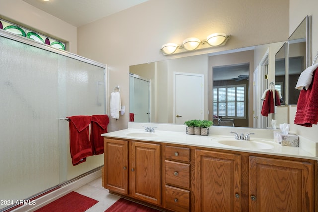 bathroom with tile patterned floors, vanity, and an enclosed shower