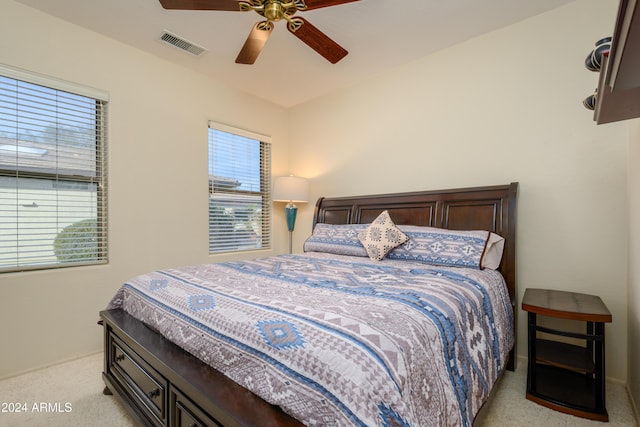 bedroom featuring ceiling fan and light carpet