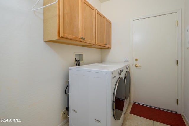 laundry room featuring light tile patterned floors, cabinets, and independent washer and dryer