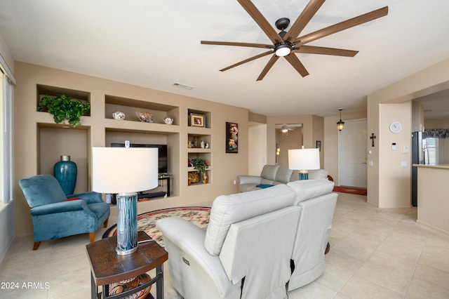 living room featuring ceiling fan, light tile patterned flooring, and built in features