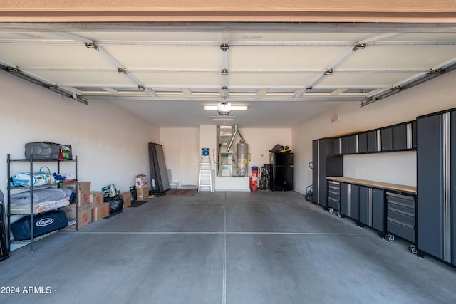 garage featuring water heater and a garage door opener