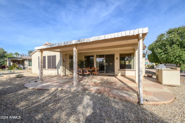 16933 W Oasis Springs Way, Surprise, AZ 85387 - back of house featuring a patio area, an outdoor kitchen, and stucco siding