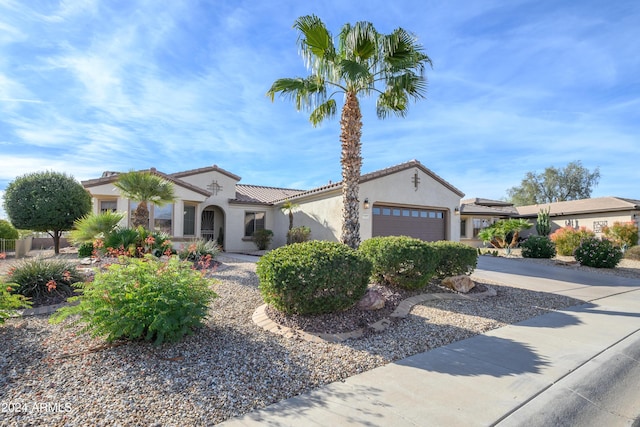 16933 W Oasis Springs Way, Surprise, AZ 85387 - mediterranean / spanish home with stucco siding, an attached garage, driveway, and a tiled roof