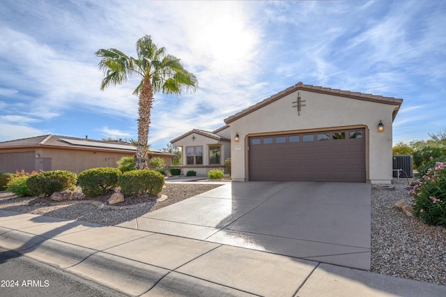 16933 W Oasis Springs Way, Surprise, AZ 85387 - mediterranean / spanish-style house featuring driveway, stucco siding, an attached garage, a tile roof, and central AC