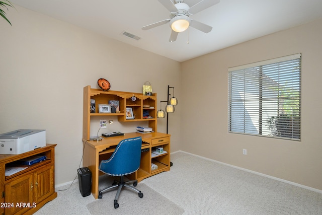 carpeted office space with ceiling fan