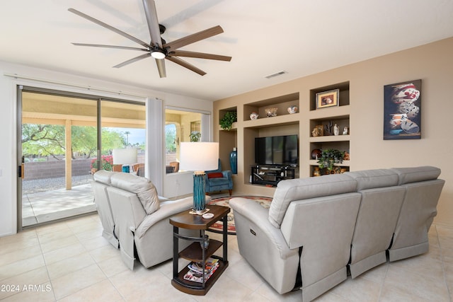 tiled living room featuring built in features and ceiling fan