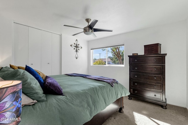 carpeted bedroom featuring a closet and ceiling fan