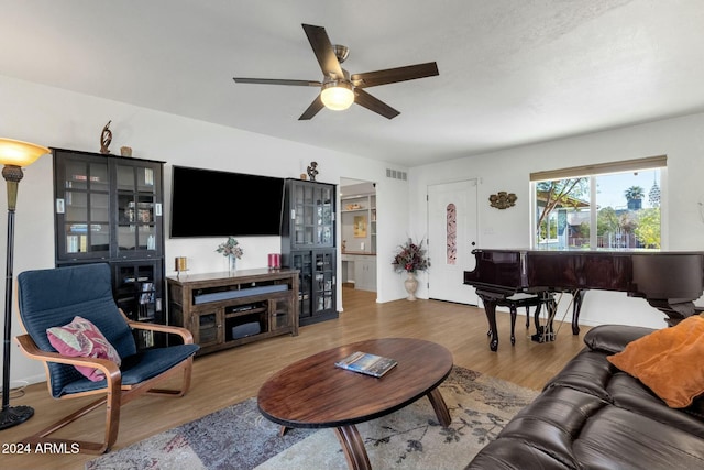 living room with ceiling fan and hardwood / wood-style floors