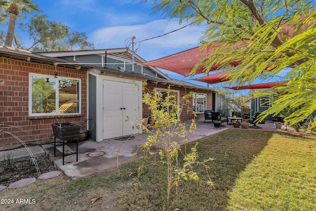 rear view of property with a patio and a lawn