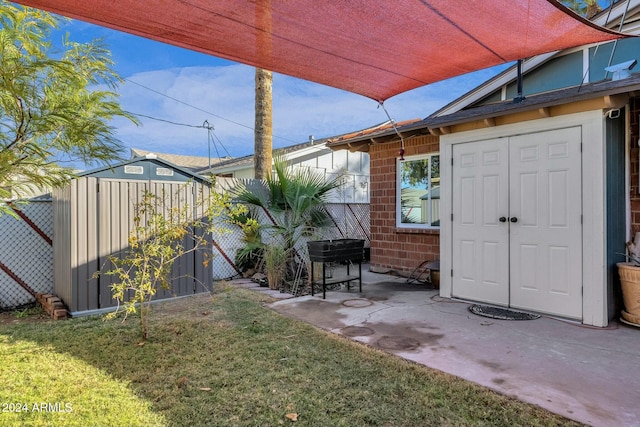 view of yard with a patio area and a storage unit