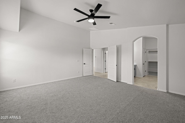3843 E Citrine Rd, San Tan Valley, AZ 85143 - unfurnished bedroom with arched walkways, light colored carpet, vaulted ceiling, baseboards, and ceiling fan