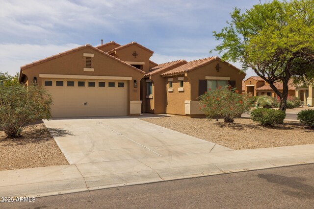 3843 E Citrine Rd, San Tan Valley, AZ 85143 - mediterranean / spanish-style house with stucco siding, a tile roof, concrete driveway, and an attached garage