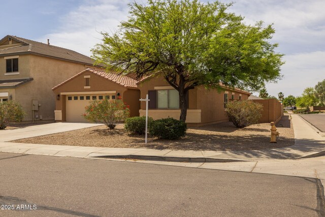 3843 E Citrine Rd, San Tan Valley, AZ 85143 - view of front of house featuring an attached garage, driveway, a tile roof, and stucco siding
