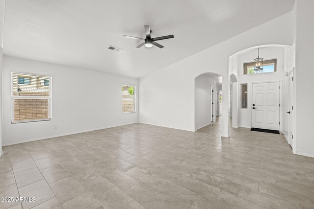 3843 E Citrine Rd, San Tan Valley, AZ 85143 - unfurnished living room featuring arched walkways, ceiling fan, and a towering ceiling