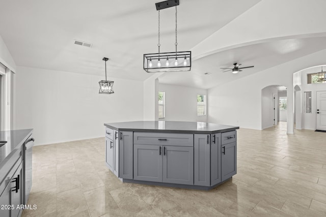 3843 E Citrine Rd, San Tan Valley, AZ 85143 - kitchen featuring arched walkways, dark countertops, gray cabinetry, vaulted ceiling, and open floor plan