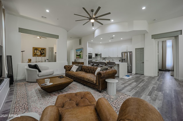 living room with light hardwood / wood-style floors and ceiling fan