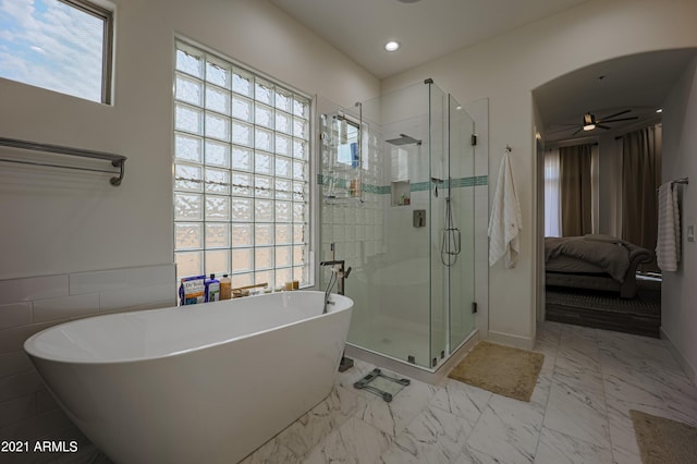 bathroom with ceiling fan and plus walk in shower